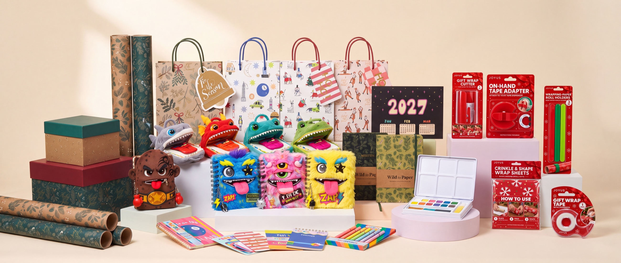 The NALM Creative product family in one shot: gift wrap, gift bags and boxes, plush and furry character notebooks, journals, a 2027 calendar, art supplies and Joyus gift wrapping accessories.